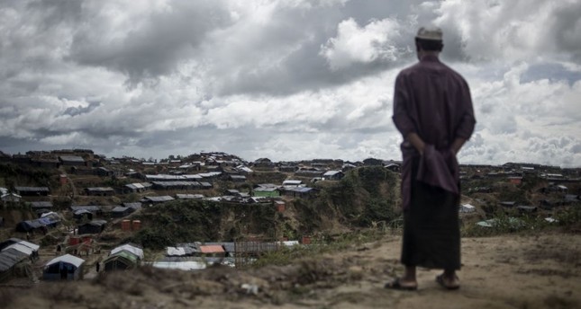 A Rohingya Muslim refugee looks on while standing in front of tents at the Balukhali refugee camp in Bangladesh's Ukhia district, Oct. 6.