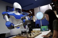 A visitor plays  a chess match against a robot during COMPUTEX in Taipei. 