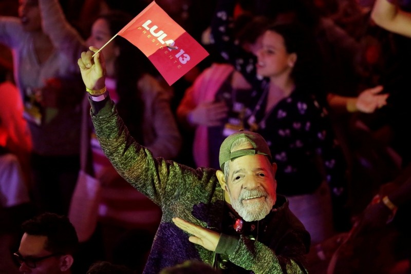 A man wears a mask depicting the Brazil's former President Luiz Inacio Lula da Silva during a Workers Party national convention in Sao Paulo, Brazil, Saturday, Aug. 4, 2018. (AP Photo)
