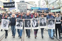 Demonstrators walk in Kassel, Germany holding posters of people killed by the NSU, April 6, 2017. 