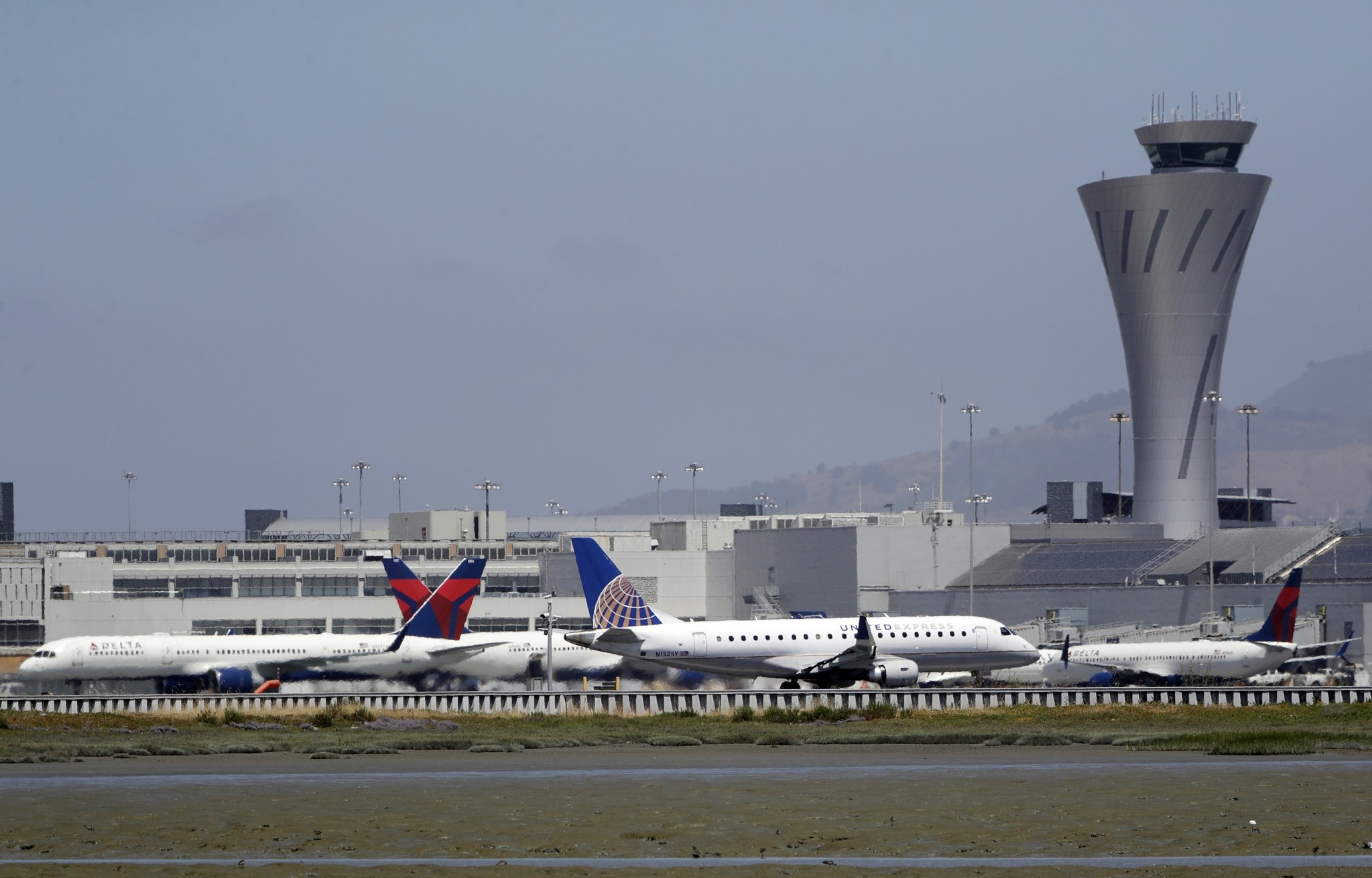 Departing and parked aircraft intersect at San Francisco International Airport, Tuesday, July 11, 2017, in San Francisco. (AP Photo)
