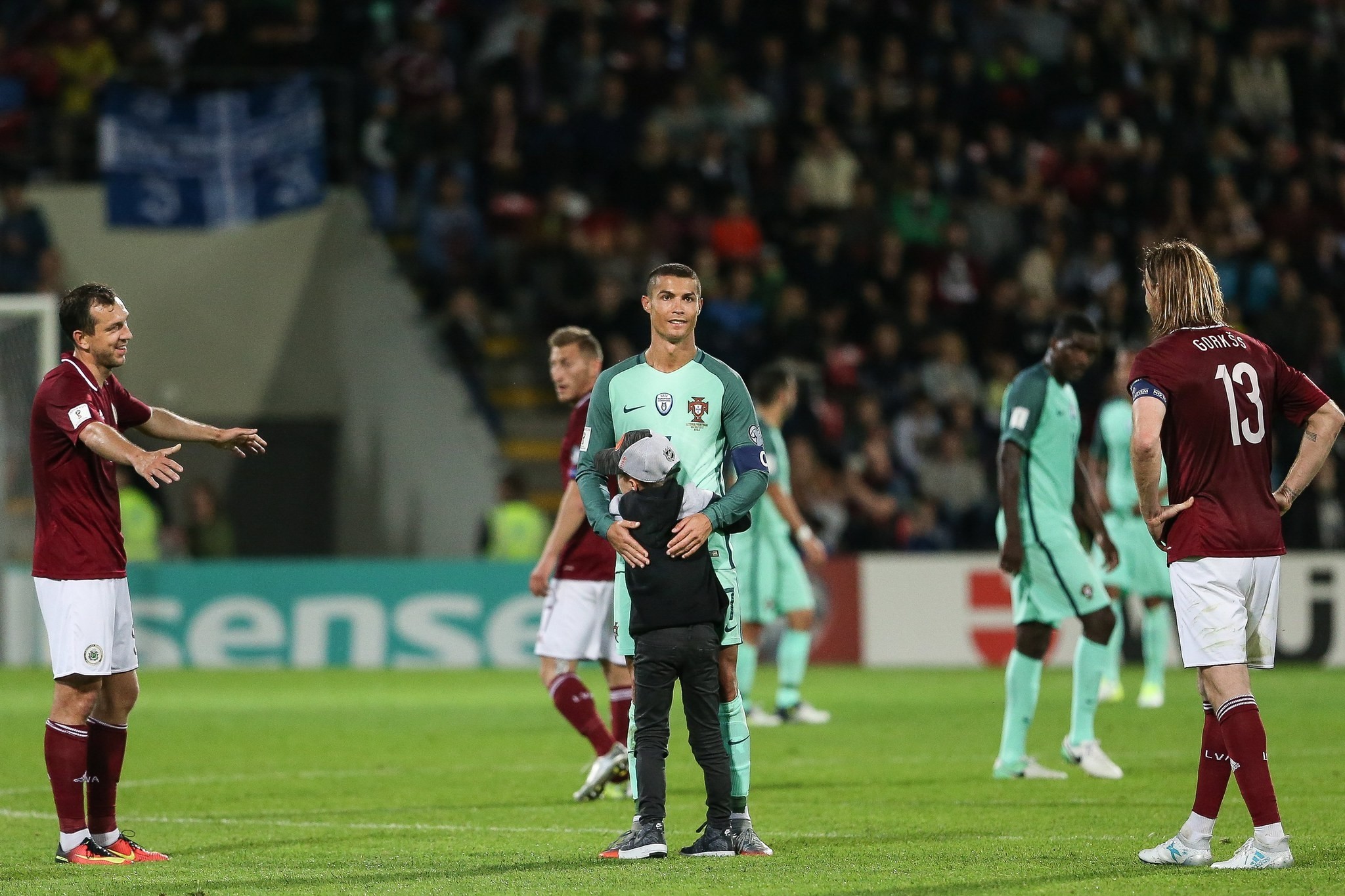 A boy hugs Portugal's player Cristiano Ronaldo after the 2018 FIFA World Cup qualifier soccer match be-tween Latvia and Portugal in Riga, Latvia, 09 June 2017. (EPA Photo) 