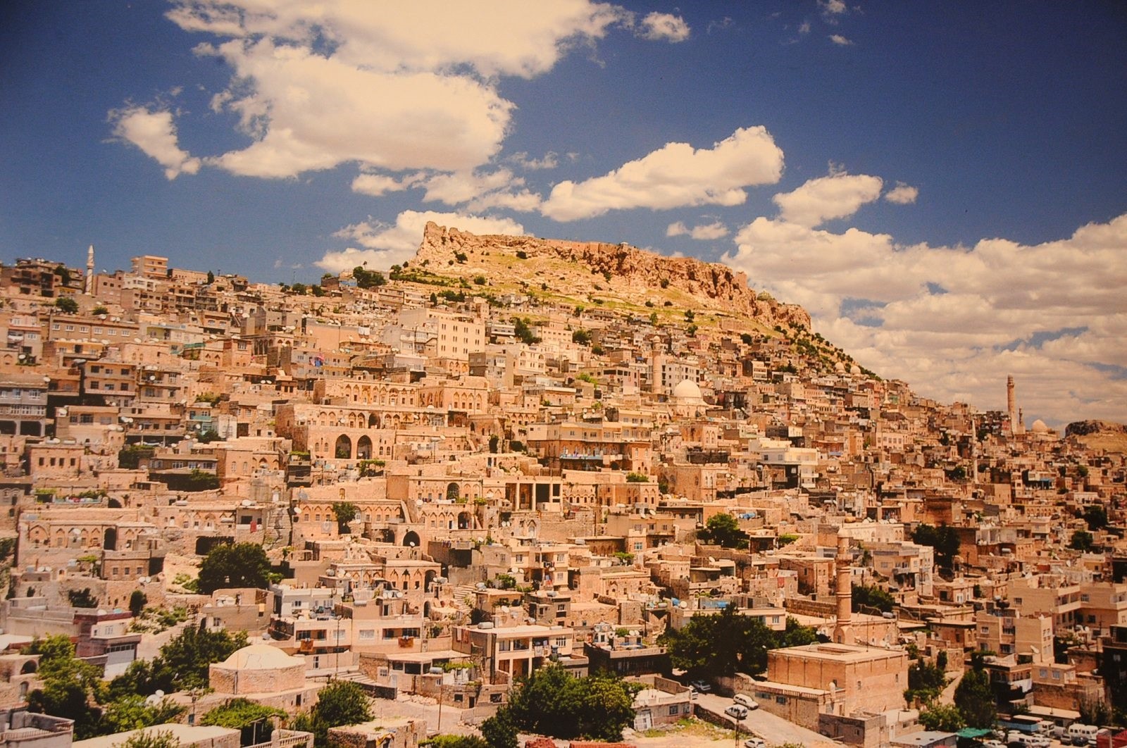 Situated on the outskirts of a hill crowned with an old castle, Mardin is known for its unique architecture composed of golden-colored houses.