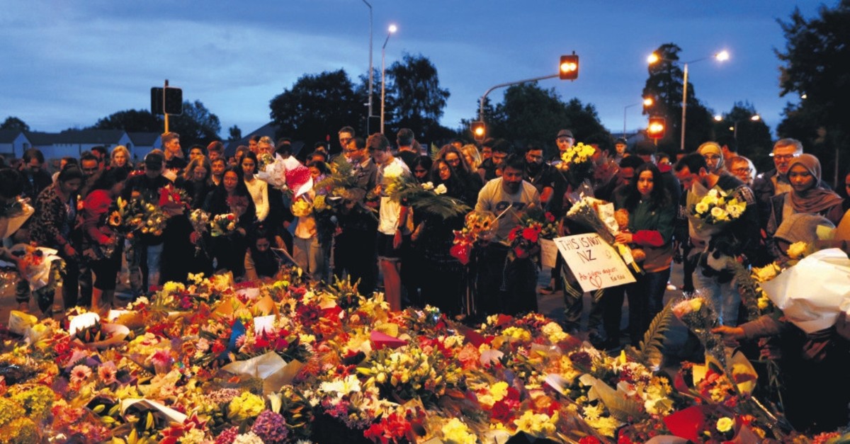 People place the flowers in tribute to the victims of the terrorist attacks against two mosques in Christchurch, New Zealand, March 17, 2019.