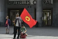 A man holds a flag of the PKK as he attends a PKK demonstration in Brussels on Aug. 8, 2015. 