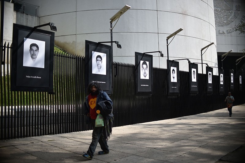 View of the portraits of the 43 students of the teaching training school in Ayotzinapa who went missing in 2014, placed on the fence of the Mexican Senate in Mexico City, on the fourth anniversary of their disappearance on Sept. 26, 2018. (AFP Photo)