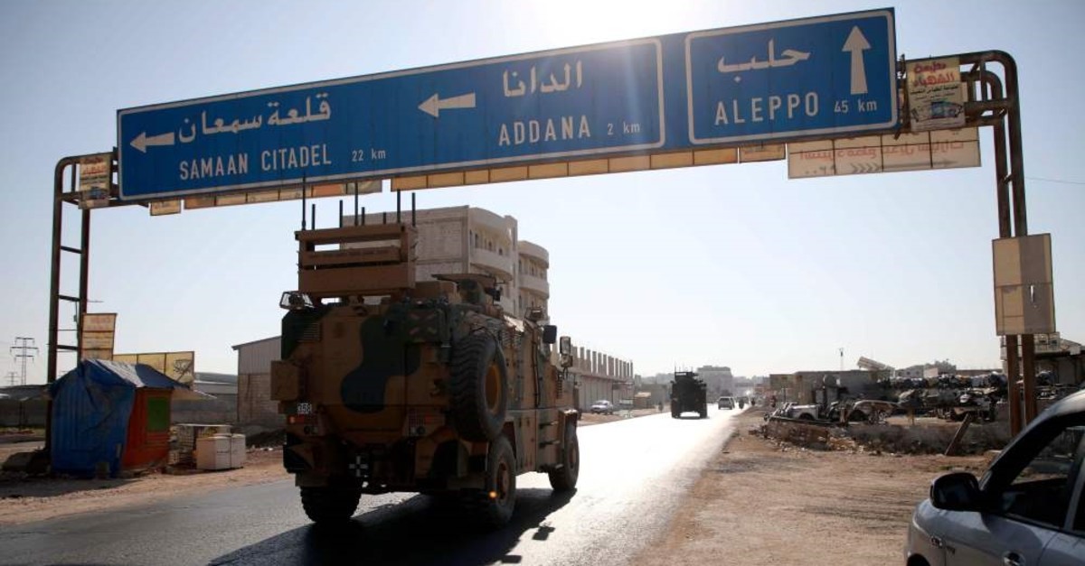A Turkish military convoy drives along the Bab al-Hawa highway on their way to reinforce a Turkish military observation post in northwestern Syria, Aug. 24, 2019.