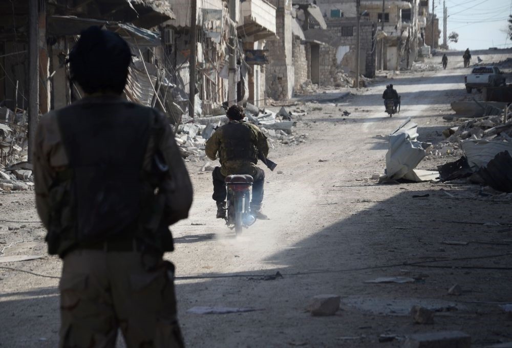 Syrian opposition patrol in the northwestern border town of al-Bab on Feb. 24, 2017 after the Turkish-backed FSA announced the recapture of the town from Daesh. 
