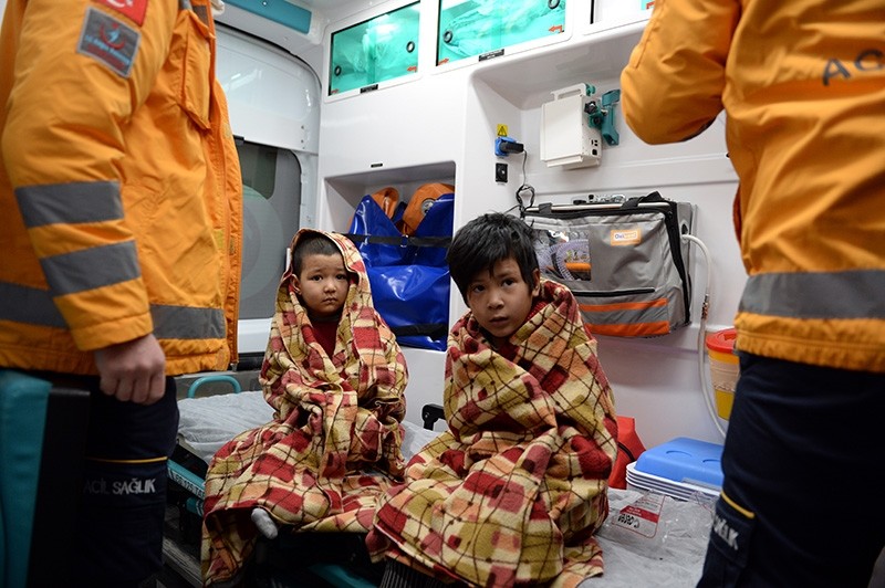 Mukaddese, 7, and Umit, 5, receive care from Turkish emergency services personnel after being rescued from their burning home in Tokat, Turkey. (AA Photo)