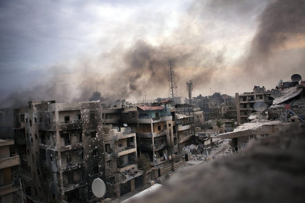 Smoke billows over shelled and destroyed buildings in Saif al-Dawle district, Aleppo, Oct. 2, 2016.