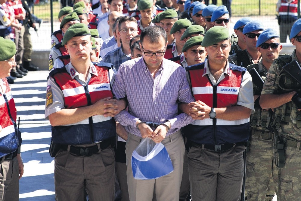Gendarmeries escort Hakan u00c7iu00e7ek to the courthouse. u00c7iu00e7ek, the owner of a college once controlled by FETu00d6, is accused of coordinating the terrorist group's infiltrators in the military who rose in the ranks to staff officers.