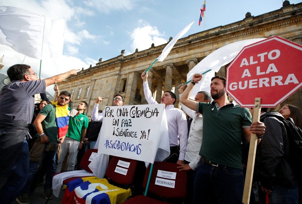 University students and supporters of the peace deal signed between the government and FARC rebels protest during a rally in front of congress in Bogota, Colombia, Oct. 3, 2016. The sign reads, u201cFor a Colombia in peace, sit here.u201d