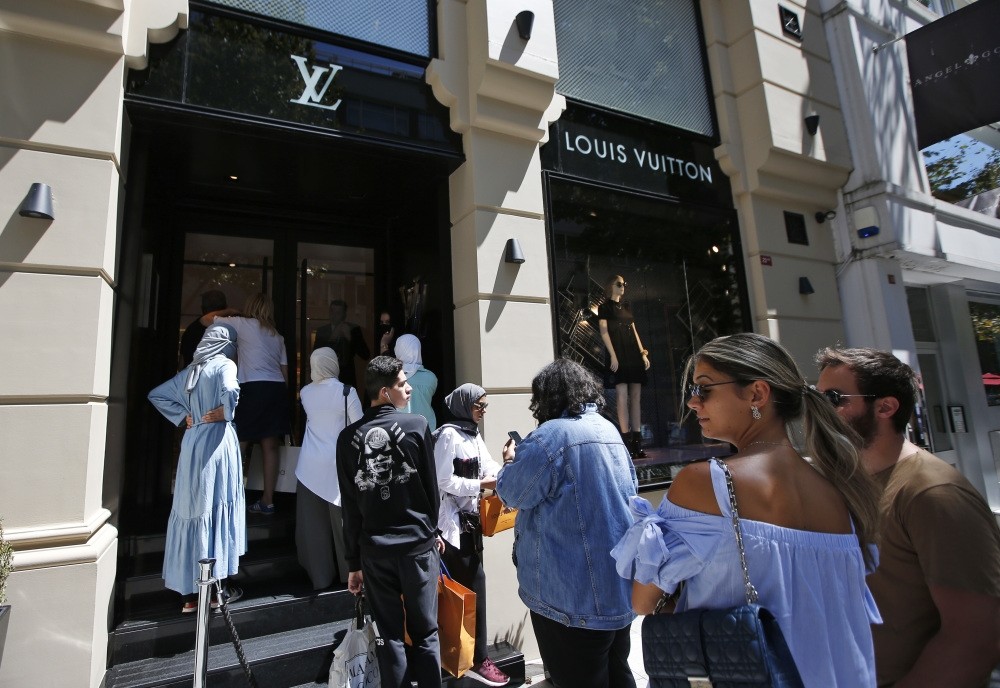 Tourists and Turks line up outside a luxury store in an upscale neighborhood, Istanbul, Aug. 14.