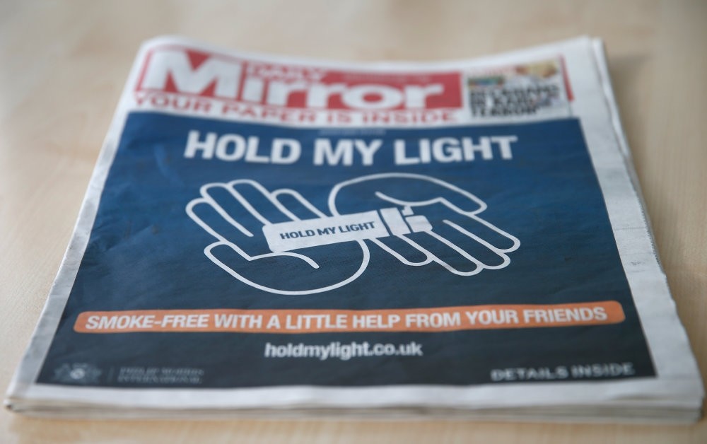 The front of a four page wraparound advertisement by Philip Morris calling on people to quit smoking for 30 days is seen on the front page of the daily Mirror in London, Oct. 22.