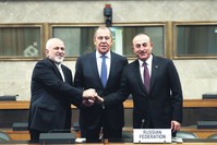 Iranian FM Mohammad Javad Zarif (L), Russian FM Sergei Lavrov (C), and FM Mevlu00fct u00c7avuu015fou011flu (R) shake hands after a joint statement following consultations on Syria, at the European headquarters of the U.N. in Geneva, Switzerland, Dec. 18.