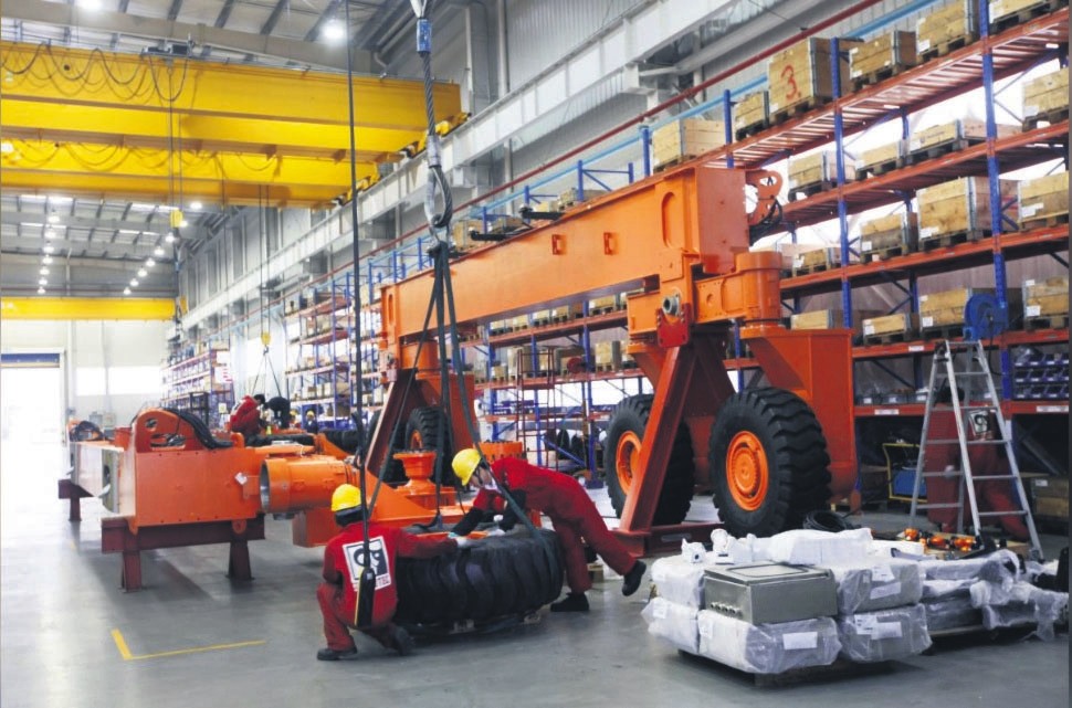 Employees work at a factory in the Shanghai Lingang Industrial Park in Shanghai, April 20, 2012.