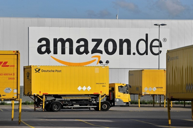  In this file photo dated Wednesday, Nov. 14, 2018, post trucks leaves the Amazon Logistic Center in Rheinberg, Germany. (AP Photo)