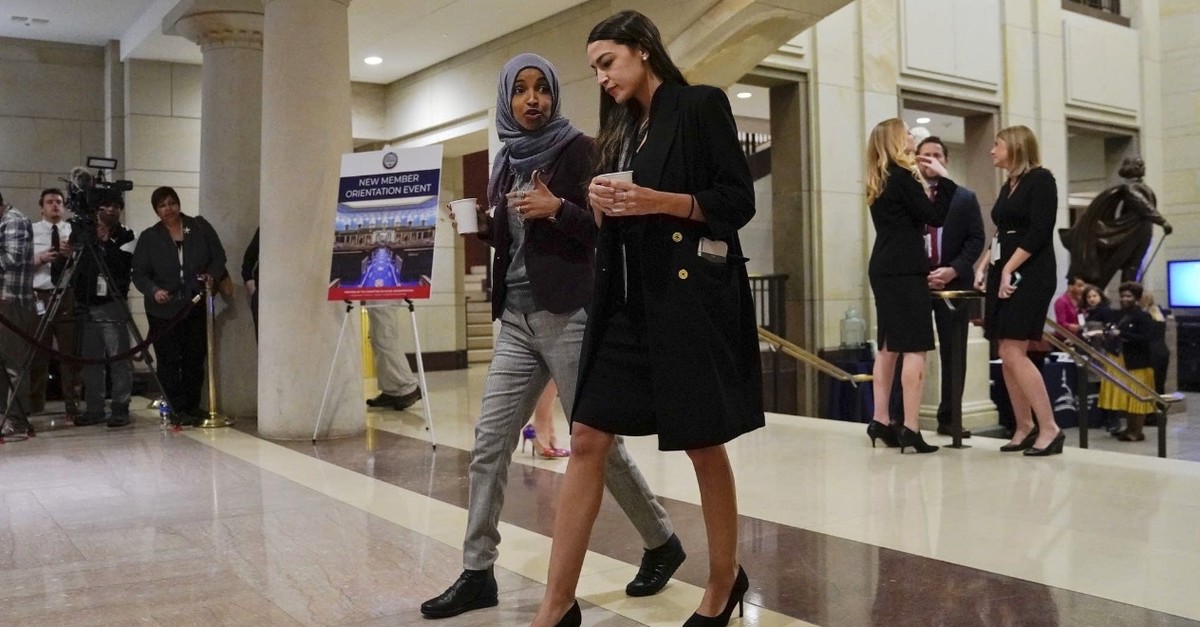 U.S. representatives Alexandria Ocasio-Cortez (R) with IIhan Omar walking in the Senate ahead of orientation program for new members, Washington, Dec. 17, 2018.