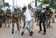 Policemen with sticks locally known as ,lathi, beat a protester during a demonstration against India's new citizenship law, Mangalore, Dec. 19, 2019 (AFP Photo)