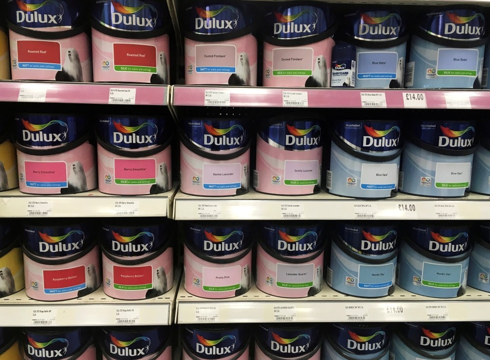 Cans of Dulux paint, an Akzo Nobel brand, are seen on the shelves of a hardware store near Manchester.