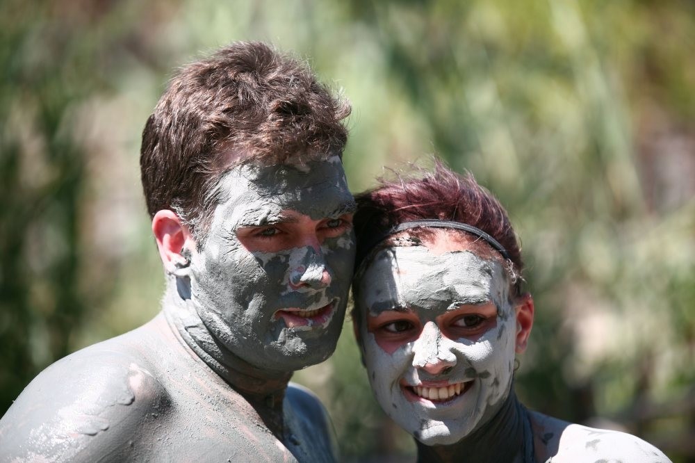 Tourists experiencing the mud bath.