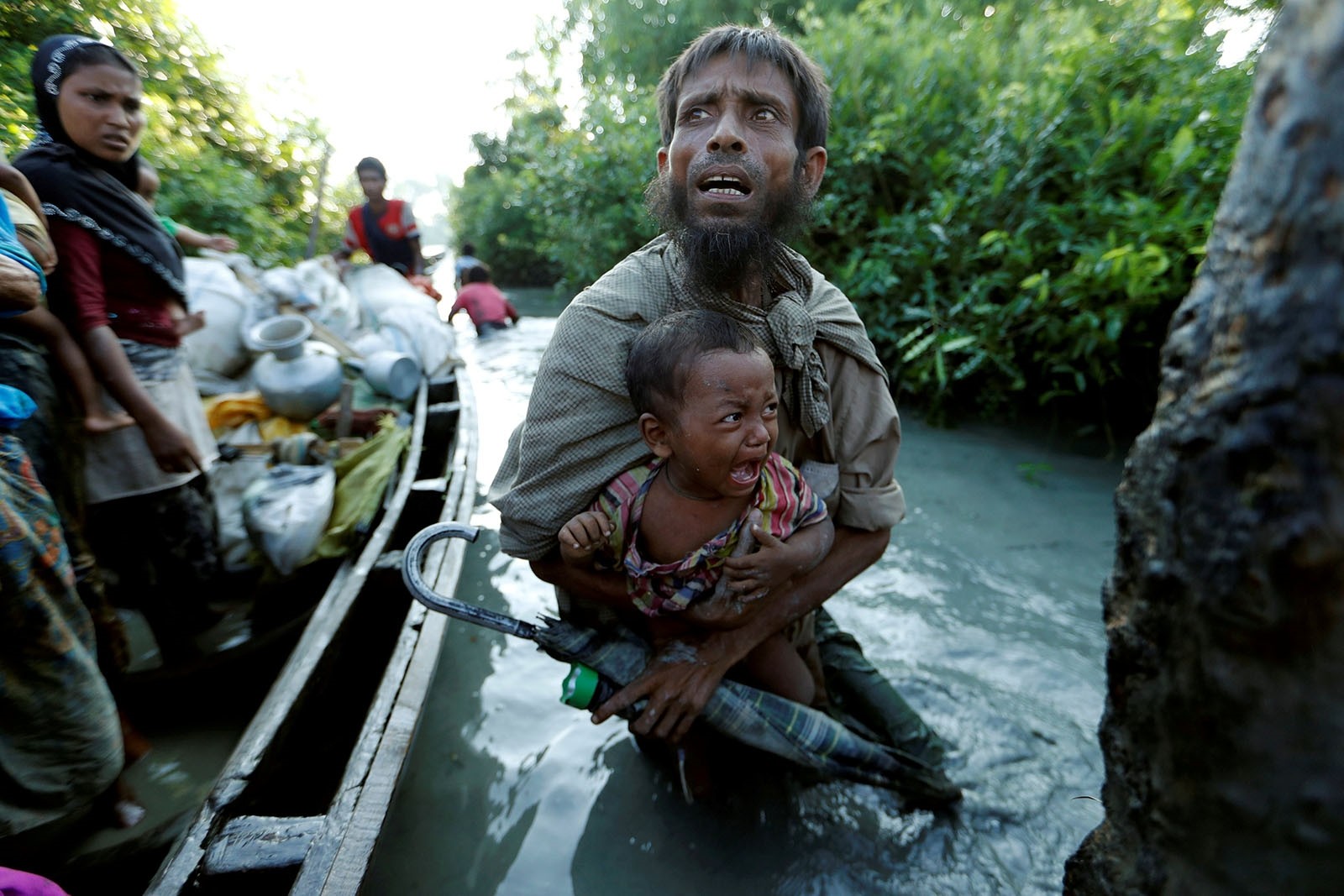 Rohingya refugees arrive at the Bangladeshi side of the Naf River after crossing the border from Myanmar, in Palang Khali, Bangladesh, October 16, 2017.