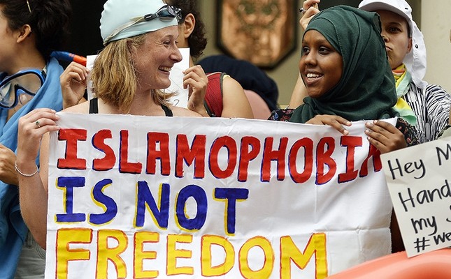 People participate in a Wear what you want beach party protest outside of t he French Embassy in London, Britain, Aug. 25, 2016. (EPA Photo)