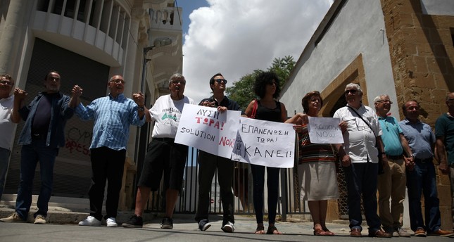 Greek and Turkish Cypriots form a human chain during a demonstration in favor of a peace settlement on divided Cyprus at Ledra's checkpoint of the United Nations patrolled green line in Nicosia May 27.