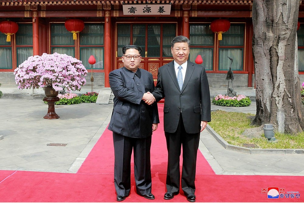 This picture from North Korea's official Korean Central News Agency (KCNA) taken on March 27, 2018 and released on March 28, 2018 shows China's President Xi Jinping (R) shaking hands with North Korean leader Kim Jong Un in Beijing.