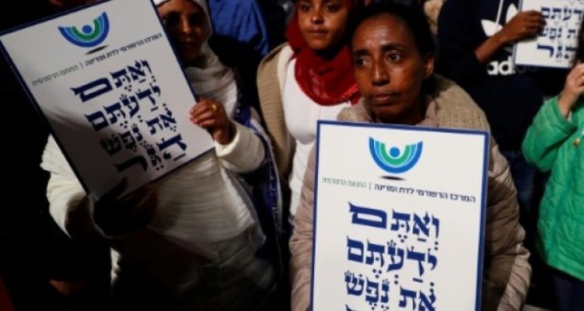 African migrants hold signs Hebrew signs: You come from the Bible, you too are refugees, during a demonstration in Tel Aviv (AFP File Photo)
