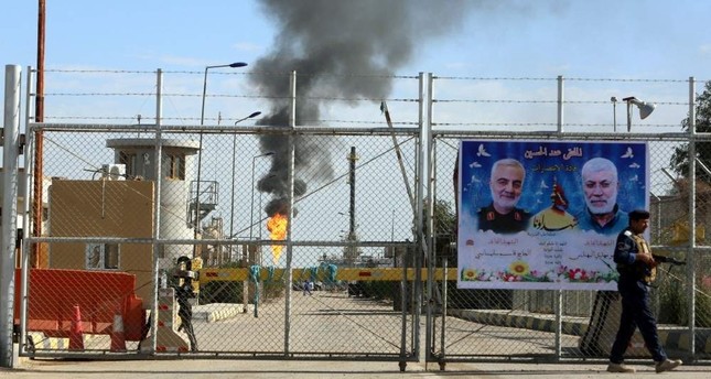 A poster of Iraqi militia commander Abu Mahdi al-Muhandis and Iranian military commander Qassem Soleimani hangs on the door of West Qurna-1 oil field, which is operated by ExxonMobil, Basra, Iraq, Jan. 9, 2020. (Reuters Photo)