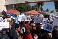 Anti-government protesters chant slogans and hold posters against the newly appointed Prime Minister Mohammed Allawi that reads, ,Rejected,, Tahrir Square, Baghdad, Feb. 2, 2020. (AP Photo)