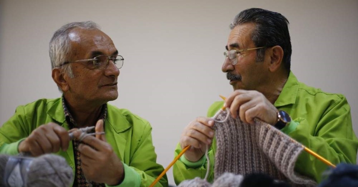 Two men are seen knitting at Senior Citizens University founded to encourage active aging in Antalya in this undated photo. (AA Photo)