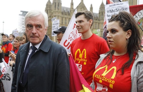 Britain's opposition Labour party's Shadow Chancellor of the Exchequer John McDonnell (L), attends a protest against working conditions and the use of zero-hour contracts at British outlets of US burger chain McDonalds, in central London on September 4, 2017