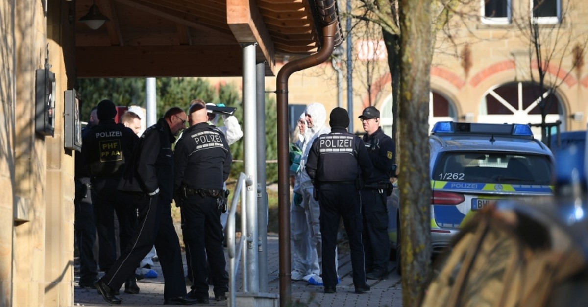 German police, including forensic experts stand at the entrance of a house after a shooter, believed to have a personal motive, launched an assault on January 24, 2020 in the town of Rot am See in southwestern Germany. (AFP Photo)