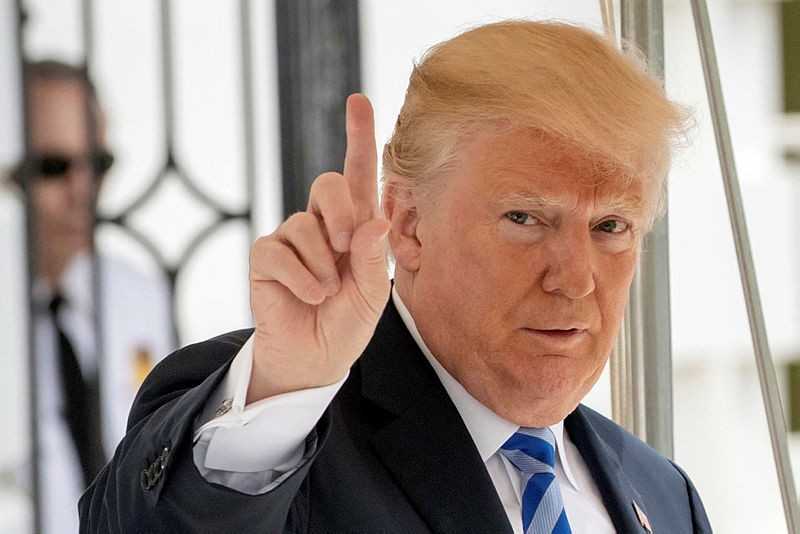 In this May 4, 2018 photo, President Donald Trump signals to the press that he will come over to talk, as he leaves the White House for Dallas to address the National Rifle Association in Washington. (AP Photo)