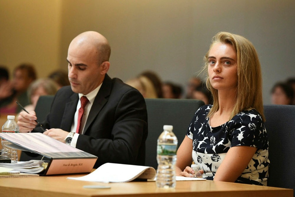 Defense Attorney makes notes as defendant Michelle Carter listens with attorney Joseph Cataldo (not shown) during her trial at Taunton Juvenile Court in Taunton, Mass., Monday, June 12, 2017. (The Boston Herald via AP)