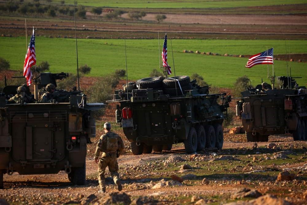 A convoy of U.S. armored vehicles drive near the village of Yalanli, on the western outskirts of the northern Syrian city of Manbij, March 5, 2017. 