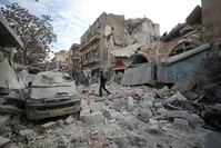 A Syrian man walks on the rubble of a building following a regime airstrike on the town of Ariha in Syria's last major opposition bastion of Idlib, Jan. 15, 2020. (AFP Photo)