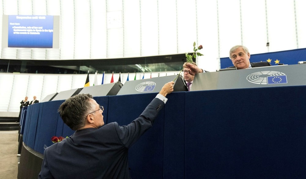 Catalan Deputy Ramon Tremosa of Convergencia i unio party hands a rose to European Parliament President Antonio Tajani in Strasbourg, Oct. 4.