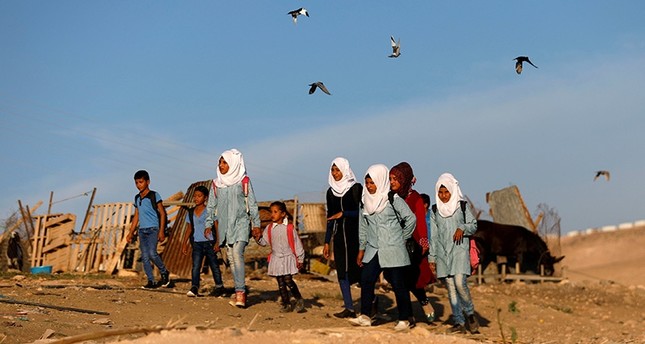Palestinian students make their way to school in the Palestinian Bedouin village of Khan al-Ahmar that Israel plans to demolish, in the occupied West Bank Oct. 16, 2018. (Reuters Photo)