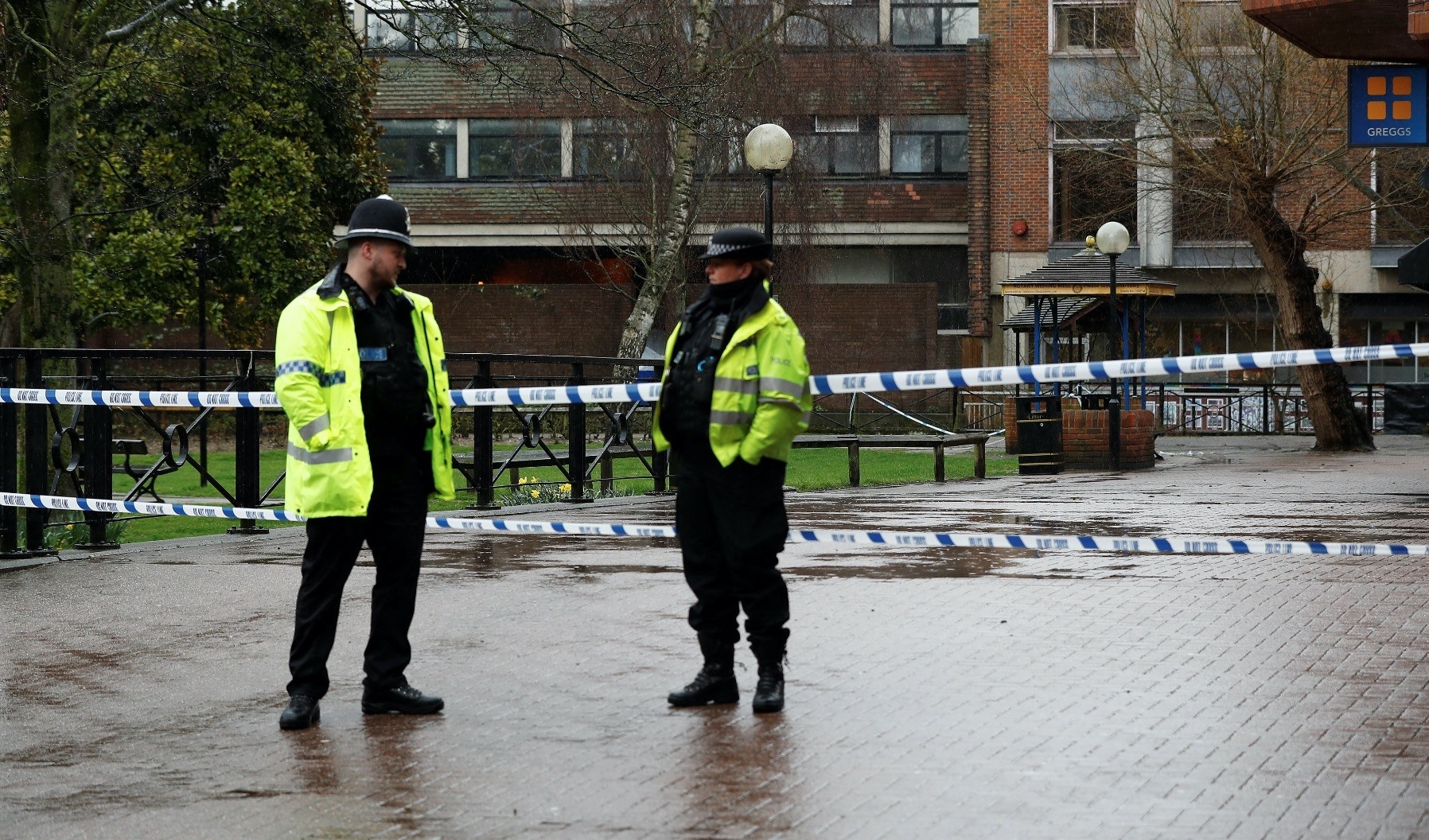 Police officers stand at cordon tape close to where former Russian intelligence officer Sergei Skripal and his daughter Yulia were found poisoned, Salisbury, Britain, March 28.