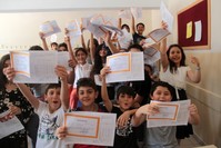 Young students at a school in the eastern city of Elazu0131u011f show their report cards.