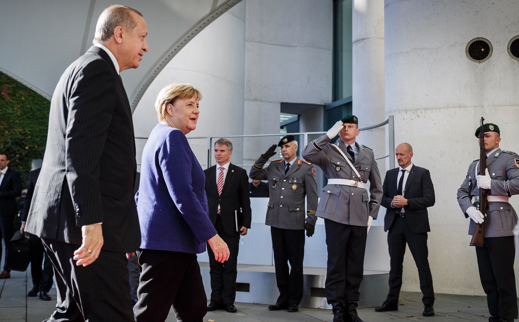 President Erdou011fan (L) and German Chancellor Angela Merkel (2-L) walk to a meeting on the future of bilateral ties at the Chancellery, Berlin, Sept. 29.  