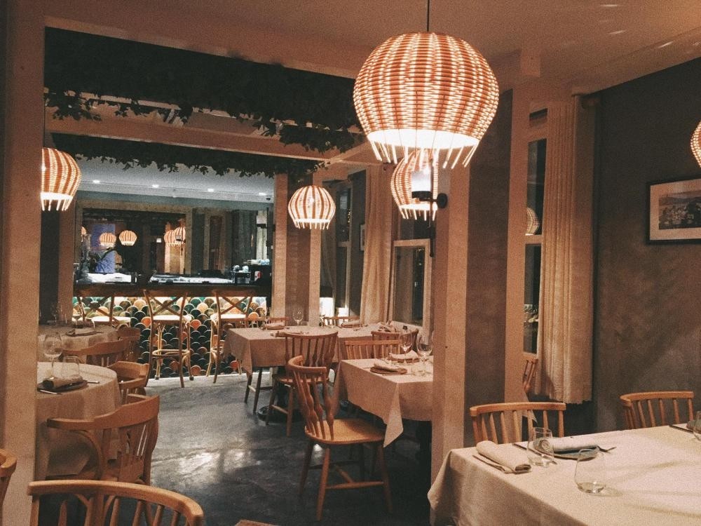 Chic lambs, wooden modern chairs, long bar area covered with green tiles gives a very Mediterranean feel at Alaf.