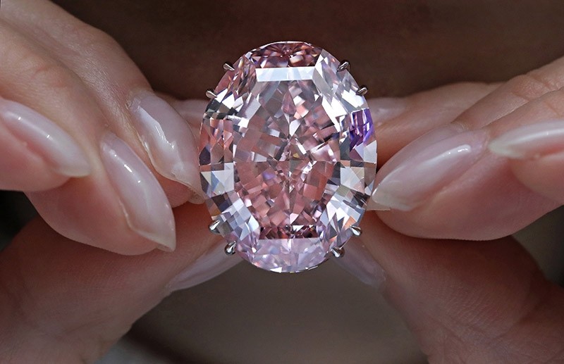 In this Wednesday, March 29, 2017, file photo, the ,Pink Star, diamond, the most valuable cut diamond ever offered at auction, is displayed by a model at a Sotheby's auction room in Hong Kong. (AP Photo)