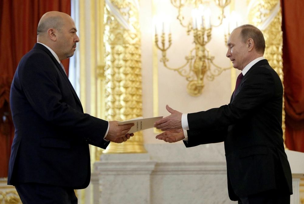 Russian President Vladimir Putin receives a letter of credence from Israeli ambassador to Russia Gary Koren during a ceremony at the Kremlin in Moscow, March 16.