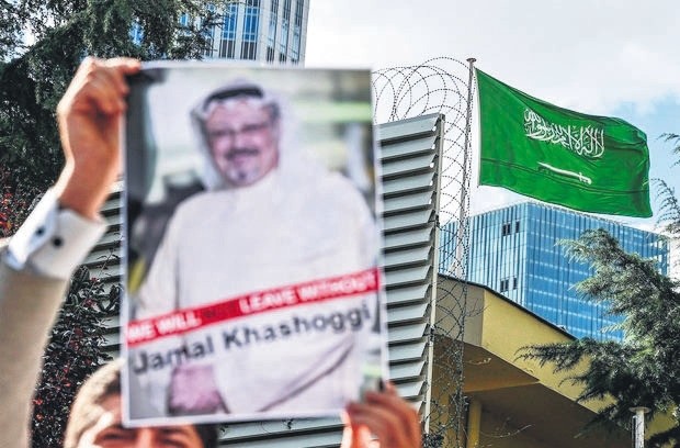 A demonstrator holds a poster with a picture of killed Saudi journalist Jamal Khashoggi outside the Saudi Arabia Consulate, Istanbul.