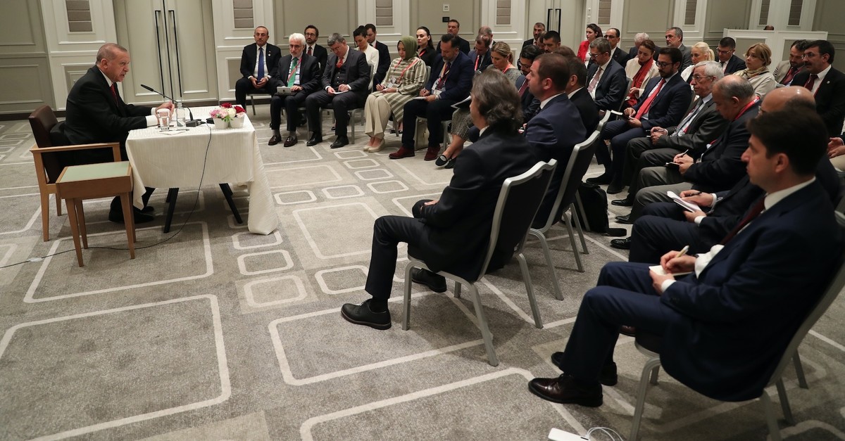 President Recep Tayyip Erdou011fan addresses accompanying Turkish journalists in Osaka, June 29, 2019.