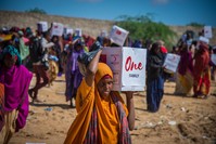 A Somalian woman carries a humanitarian aid delivered by Turkish Red Crescent during drought hit the country earlier this year. 